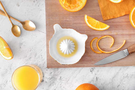 Ceramic juicer and oranges on light backgroundの写真素材