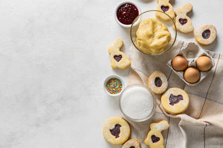 Tasty Easter cookies and ingredients on light backgroundの写真素材