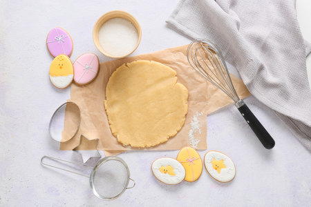 Fresh dough for preparing tasty Easter cookies on light backgroundの写真素材