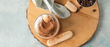 Sweet tasty tiramisu on table, top view