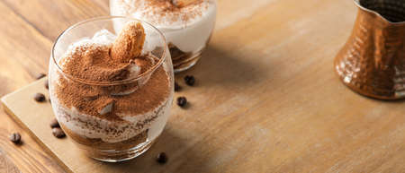 Sweet tasty tiramisu on wooden table, closeupの写真素材