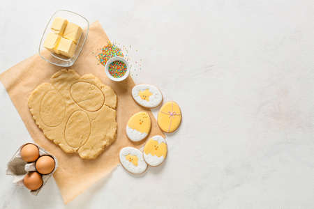 Fresh dough, Easter cookies and ingredients on light backgroundの写真素材