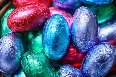 Chocolate Easter eggs wrapped in color foil, closeup