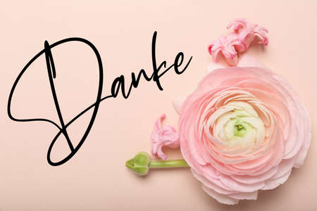 Beautiful flowers and word DANKE (German for Thanks) on pink background