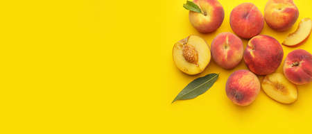 Many ripe peaches on yellow background with space for text