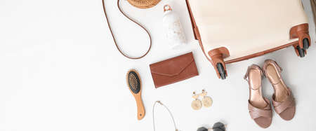 Suitcase with travel accessories on white background with space for text