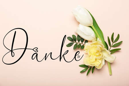 Beautiful flowers and word DANKE (German for Thanks) on pink background
