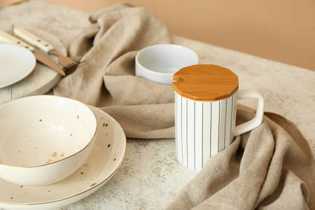 Cup and plates on light served table