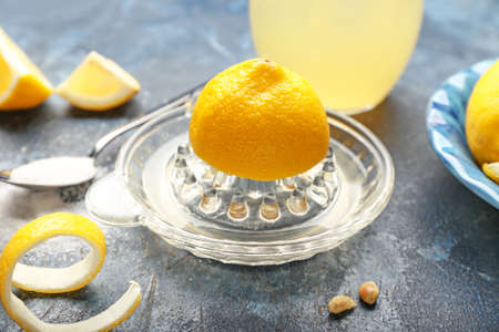 Juicer with ripe lemon on color background, closeupの写真素材