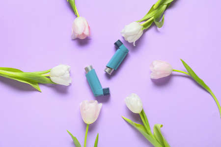 Composition with beautiful tulip flowers ad inhalers on lilac backgroundの写真素材