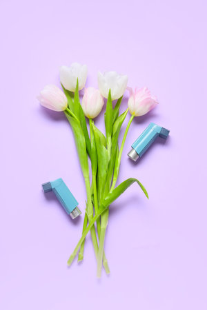 Beautiful tulip flowers and inhalers on lilac backgroundの写真素材