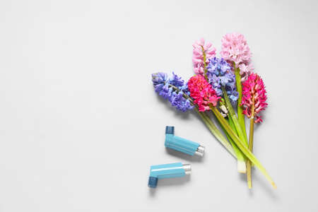 Bouquet of beautiful hyacinth flowers and inhalers on white backgroundの写真素材