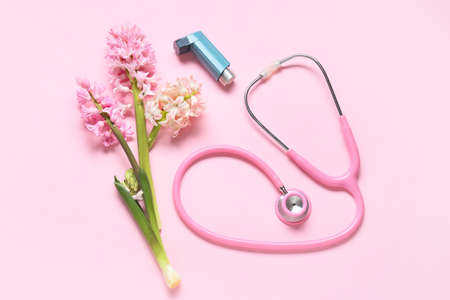 Composition with inhaler, stethoscope and hyacinth flowers on pink backgroundの写真素材
