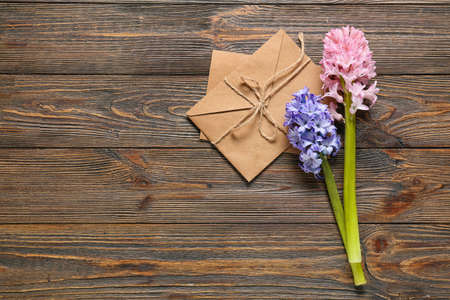 Envelope and beautiful hyacinth flowers on wooden backgroundの写真素材