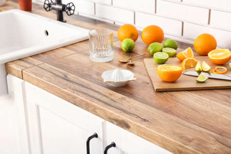 Ceramic juicer and citrus fresh on kitchen counter