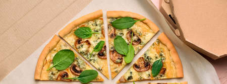 Cardboard box with tasty mushroom pizza, top viewの写真素材