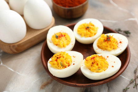 Plate with tasty stuffed eggs on grunge background, closeup. easter celebration