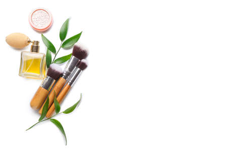 Cosmetics and makeup brushes isolated on white
