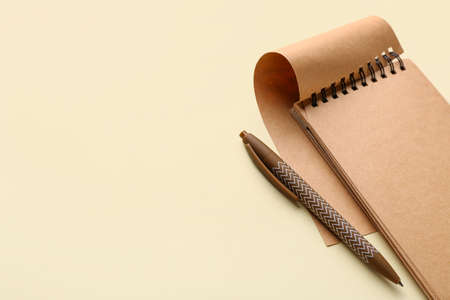 Notebook and pen on light color background