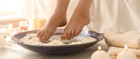 Young woman undergoing spa pedicure treatment in beauty salonの写真素材