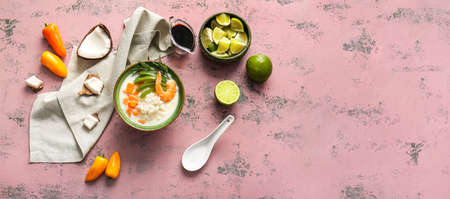 Bowl with tasty Thai soup on color background with space for textの写真素材