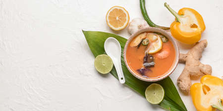 Bowl of spicy Thai soup on white background with space for textの写真素材