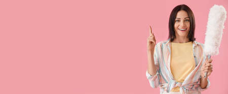 Young woman with pp-duster on pink background with space for text