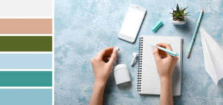 Female hands with notebook and gadgets on blue background. Different color patternsの写真素材