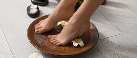 Young woman undergoing spa pedicure treatment in beauty salonの写真素材