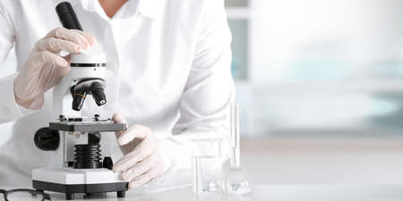 Scientist using microscope in laboratoryの写真素材
