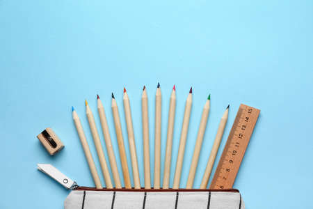 Pencil case with school stationery on blue backgroundの写真素材