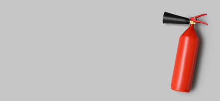 Fire extinguisher on gray background with space for textの写真素材