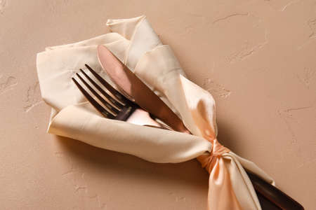 Cutlery with napkin on color backgroundの写真素材