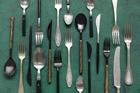 Many different cutlery on green background, top viewの写真素材