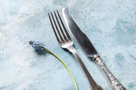 Cutlery with Muscari flower on blue background, closeupの写真素材