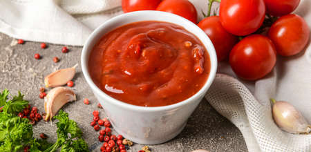 Bowl of organic tomato sauce on grunge backgroundの写真素材