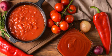Organic tomato sauce on wooden background, top viewの写真素材