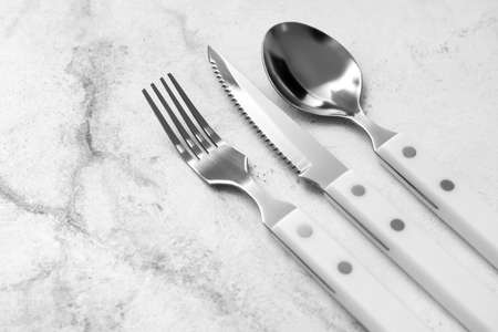 Silver cutlery on light backgroundの写真素材