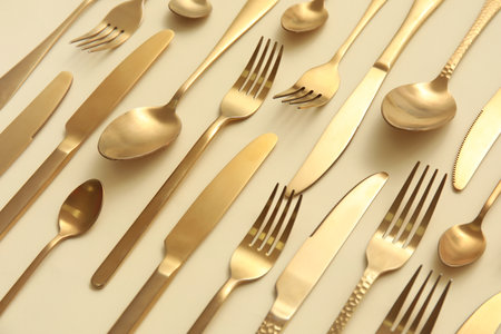 Many different golden cutlery on color backgroundの写真素材