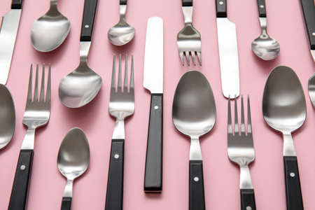 Many different cutlery on pink backgroundの写真素材