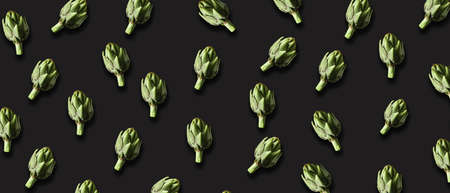 Many green artichokes on black backgroundの写真素材