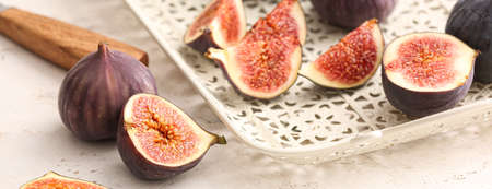 Tray with fresh figs on light background, closeup