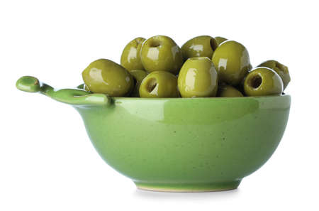 Bowl full of green olives isolated on white backgroundの写真素材