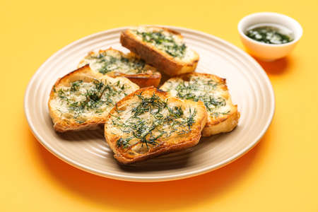 Plate of tasty toasts with garlic and dill on color background, closeupの写真素材