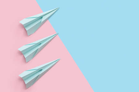 Paper planes on pink and blue background