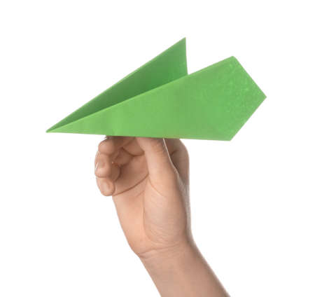 Woman with green paper plane on white backgroundの写真素材
