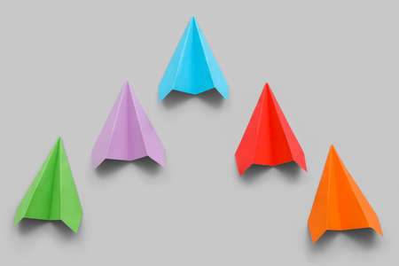 Colorful paper planes on gray background