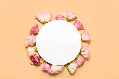 Blank paper sheet with pink flowers on beige backgroundの写真素材