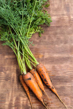 Fresh juicy carrots on wooden backgroundの写真素材