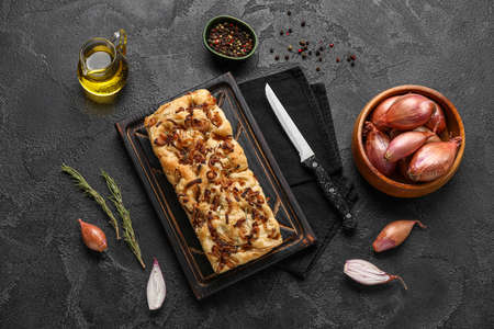 Composition with tasty Italian focaccia and ingredients on dark backgroundの写真素材